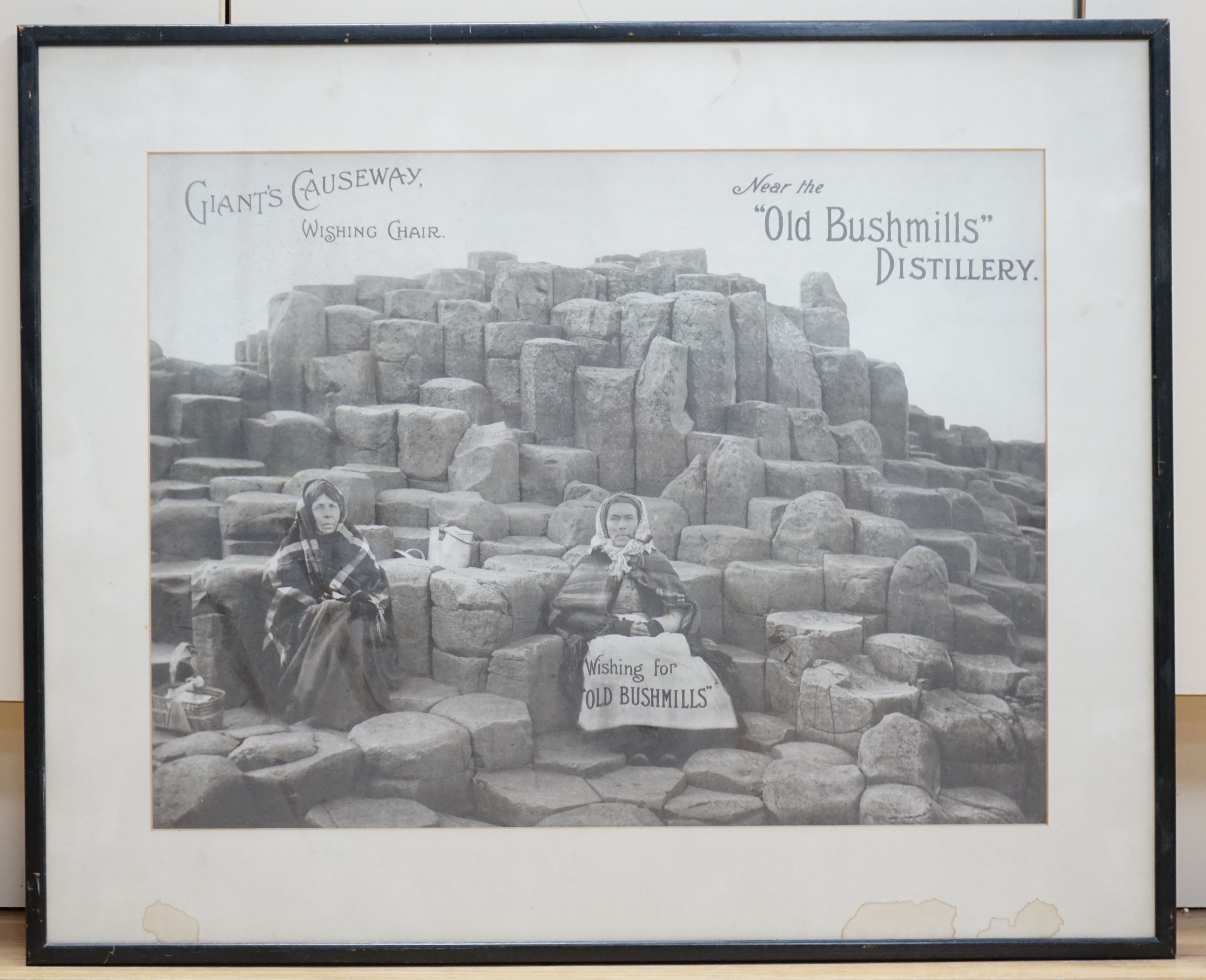 A monochrome advertising print for Old Bushmills Distillery, Giants Causeway, Wishing Chair, 39 x 52cm